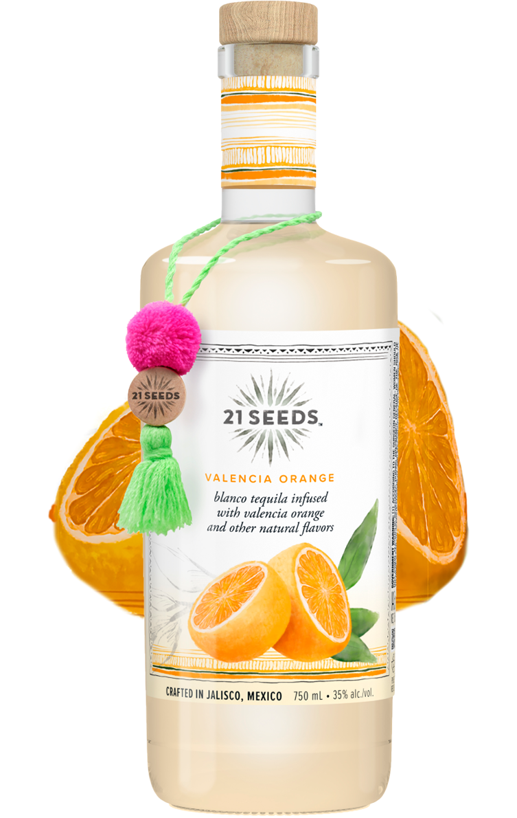 A bottle of 21SEEDS Valencia Orange Blanco Tequila. Behind the bottle is two orange halves.